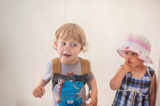 Toddlers Boy And Girl Pressed His Nose To The Glass