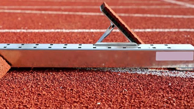 Dolly of athletic starting block in a stadium