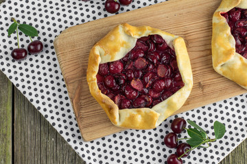 Top View on Rustical Sour Cherry Pie on Wooden Board with a few