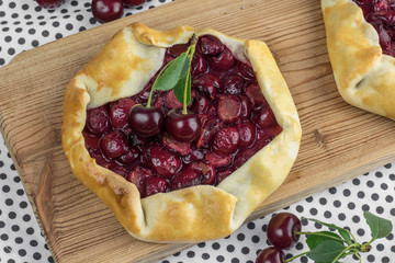 Rustical Sour Cherry Pie with Sour Cherries on Wooden Board