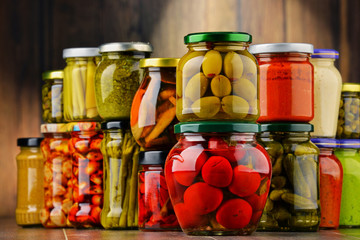 Jars with variety of pickled vegetables.