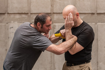 Kapap instructor demonstrates self defense techniques against a gun point. Gun Disarm.