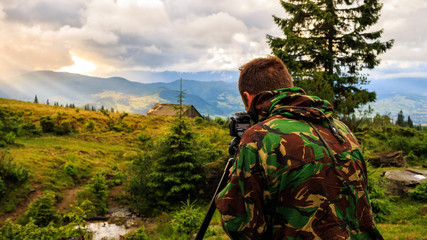 Naklejka premium Photographer taking photo of mountain landscape, Carpathian, Ukraine