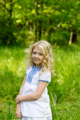 Naklejka na ściany i meble Portrait cute blonde girl outdoors in summer