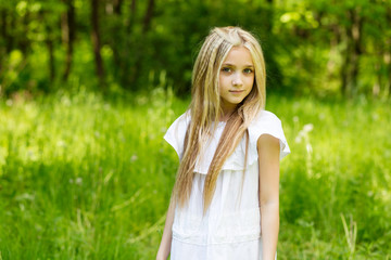 Fototapeta na wymiar Portrait cute blonde girl outdoors in summer