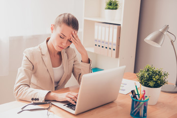 Young pretty businesswoman tired from work in the office