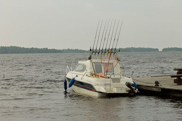 Fishing boat standing at the pier on a cloudy day