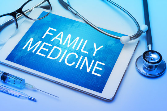 Family Medicine Word On Tablet Screen With Medical Equipment On Background