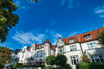 Architectural buildings along the Alster canal in Hamburg Germany
Luxury old mansions Winterhude neighbourhood against blue sky on sunny summer day, image for real estate agent business realtor blog - 117114455