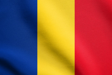 Obraz premium Flag of Romania waving in wind with fabric texture