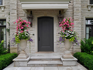 front door of stone house with large flower pots