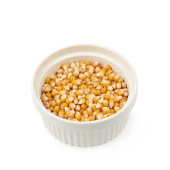 White ramekin filled with corn kernels