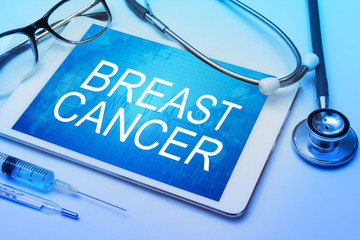 Breast Cancer word on tablet screen with medical equipment on background