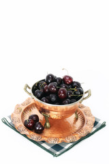 Cherries in a copper colander with copy space above