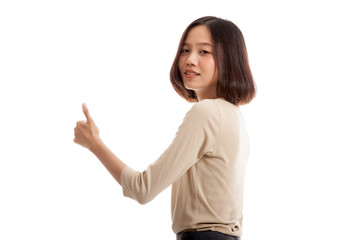 Young Asian businesswoman turn back thumbs up