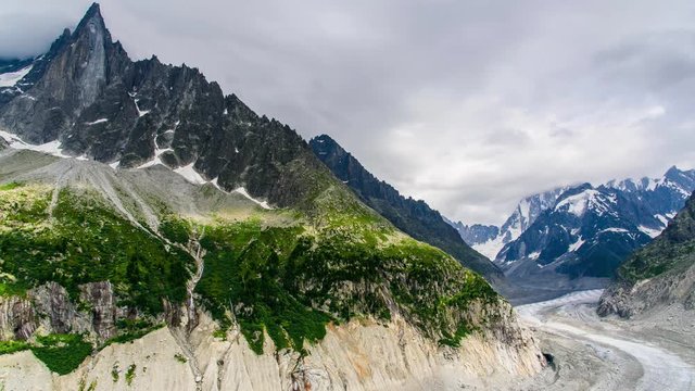 Timelapse of Drus , Mer de Glace glacier and Grandes Jorasses in the Mont Blanc massif during the cloud and rainy day in summer at Chamonix, French Alps