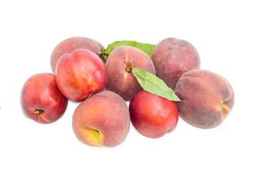 Several peaches and nectarines on a light background