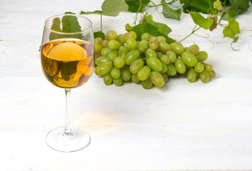 glass of white wine with grapes