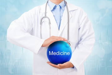 Doctor holding blue crystal ball with medicine sign on medical background.