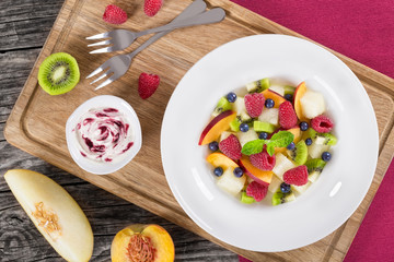 fruit  and berry summer dessert salad decorated with mint