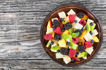 delicious fruit  and berry summer salad decorated with mint