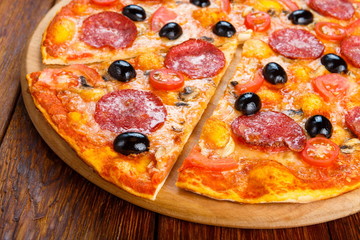 Delicious pizza with salami, mushrooms and olives