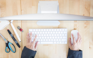 Top View Of Asian Woman Hand Working With Computer On Wooden Table.