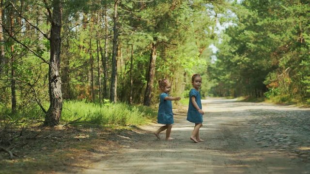 Two beautiful girls walking in the woods