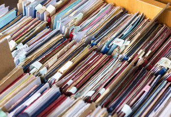 File folders in a file cabinet, card catalog in a library, close