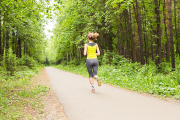 young fitness woman runner running on trail