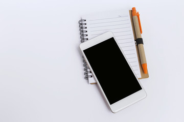 Smartphone on blank notebook with space on white background