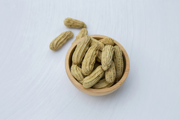 Steamed peanut in wooden bown on white texture background