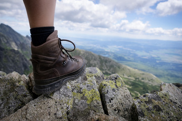 Hiking in Slovakia mountains. Detail view of heavy hiking shoe. Leather boot in a difficult terrain.