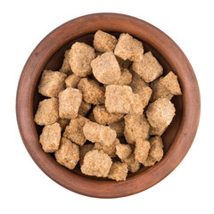 Cubes of whole cane sugar in bowl, isolated on the white backgro