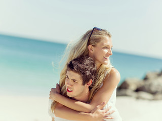 Portrait of man carrying girlfriend on his back