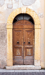 Fototapeta na wymiar Old weathered wooden doors in Italy 