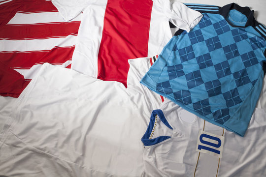 Colorful soccer jerseys laid out on the floor