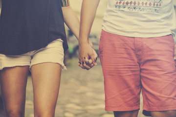 Modern couple in love holding hands.