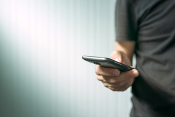 Casual man using smart phone to send text message