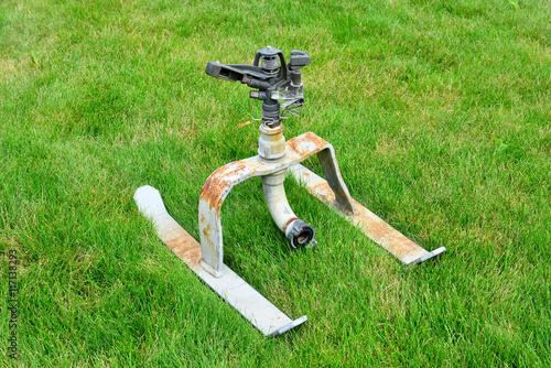 "Rasensprenger aus Gusseisen auf einer Wiese" Stockfotos und