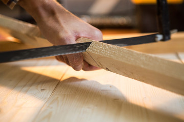 man sawing a board