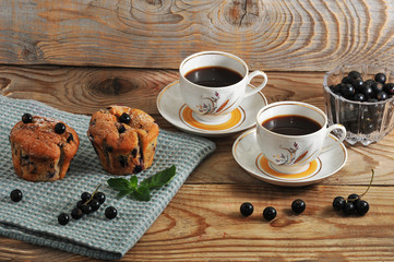rustic muffins with black currant and two cup of coffee