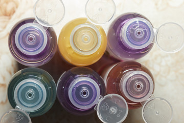 colored bottles for cosmetics, cosmetics and shampoos, top view