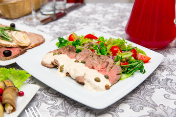 Dish with sliced meat products