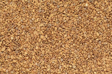 Organic Cinnamon (Cinnamomum verum) in tea cut size. Macro close up background texture. Top view.