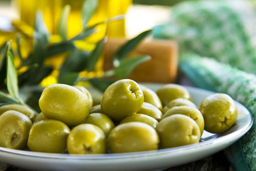 dish of olives on wooden background