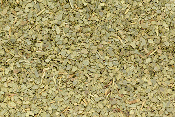 Organic dry Indian bay leaf (Cinnamomum tamala) in tea cut size. Macro close up background texture. Top view.