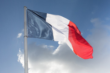 Naklejka na ściany i meble Flag of France, waving in the wind, on the sky