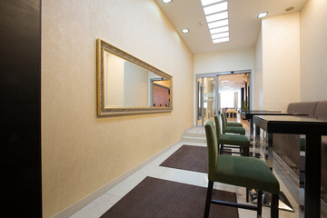 Hotel corridor with bar stools and tables