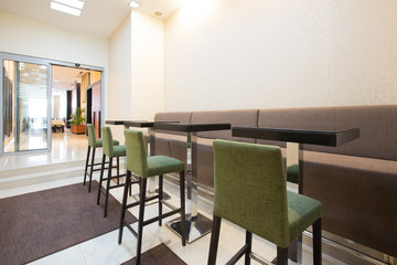 Hotel corridor with bar stools and tables